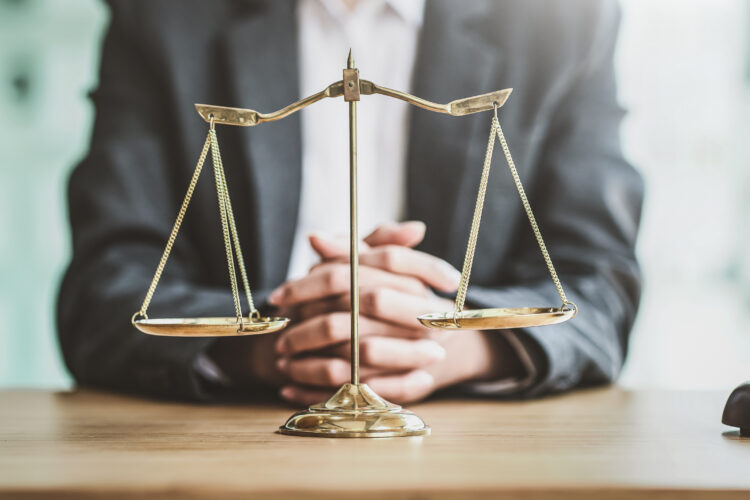 Close up golden scales with blurry lawyer as background.