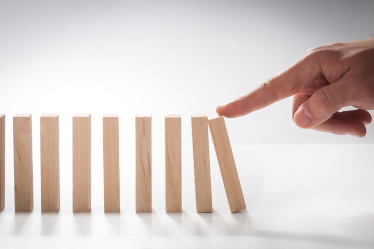 Hand Pushing Domino Pieces